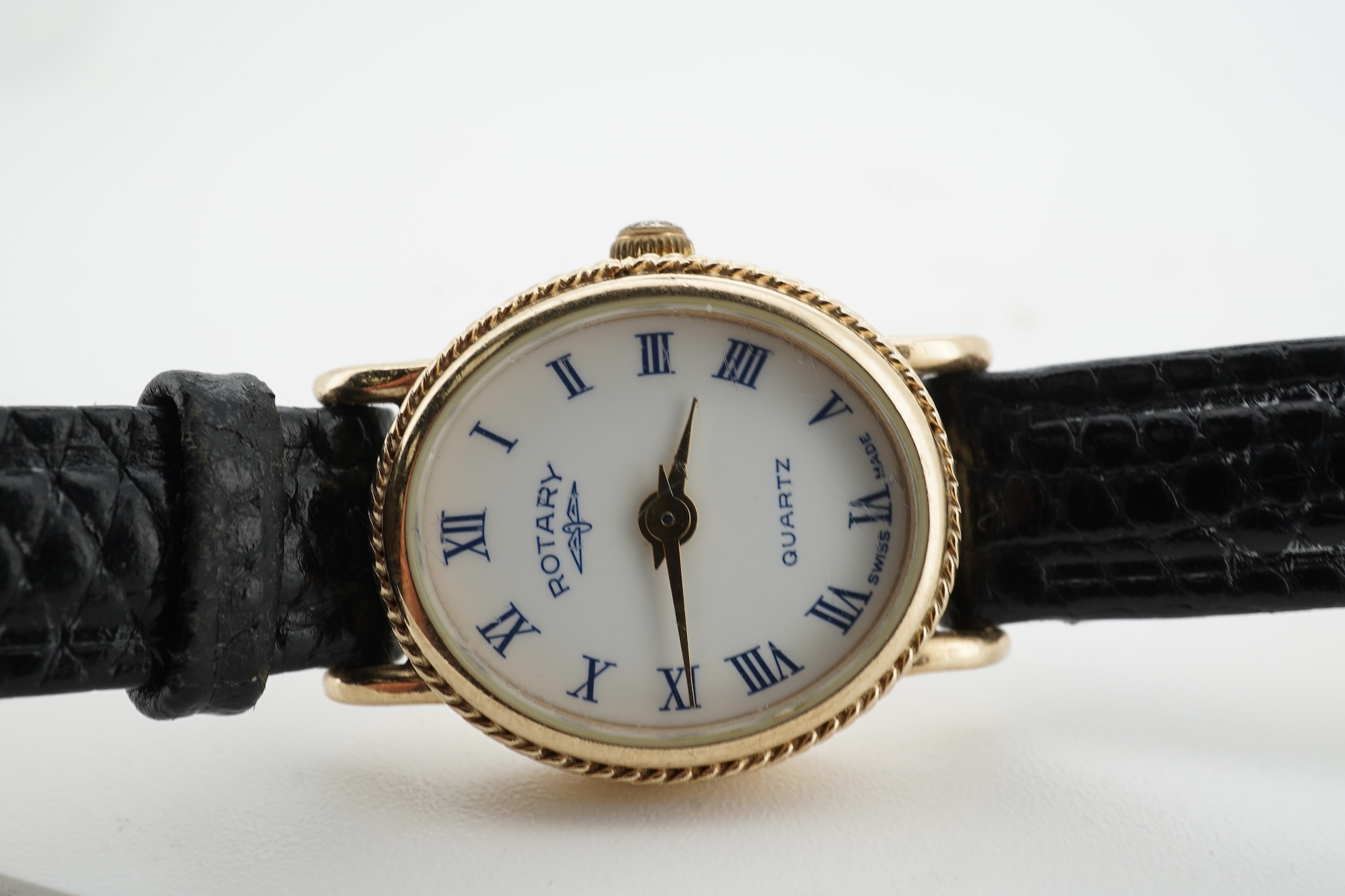 A lady's recent 9ct gold Rotary quartz wrist watch, with oval Roman dial, case diameter 18mm, on an associated leather strap, no box or papers.
